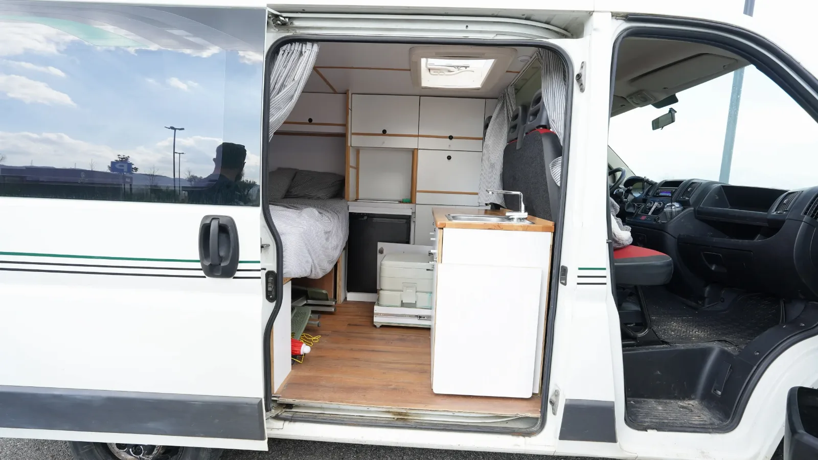 Side door open on the Fiat Ducato campervan, showing the interior and cab