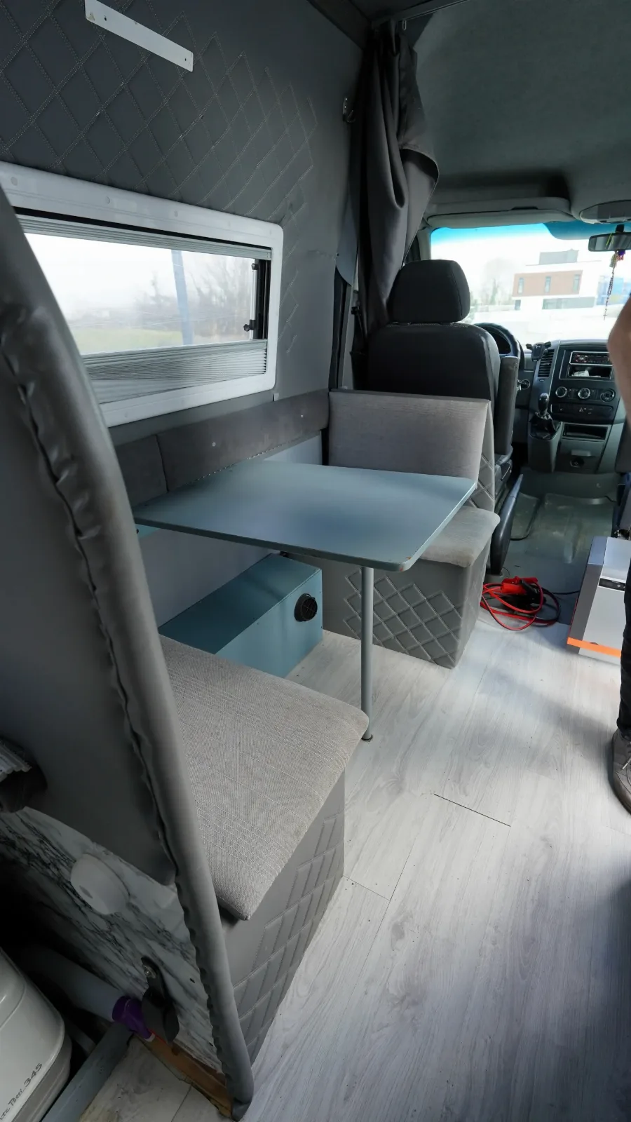 Table and cab seat in the Mercedes-Benz Sprinter campervan