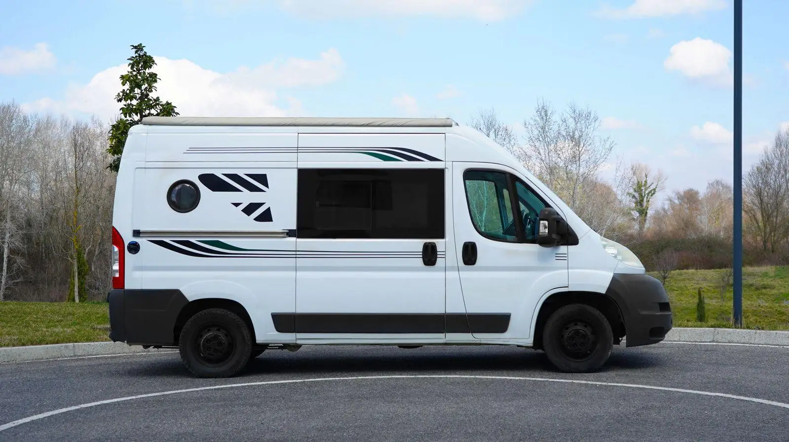 Peugeot Boxer campervan in side profile with decal striping