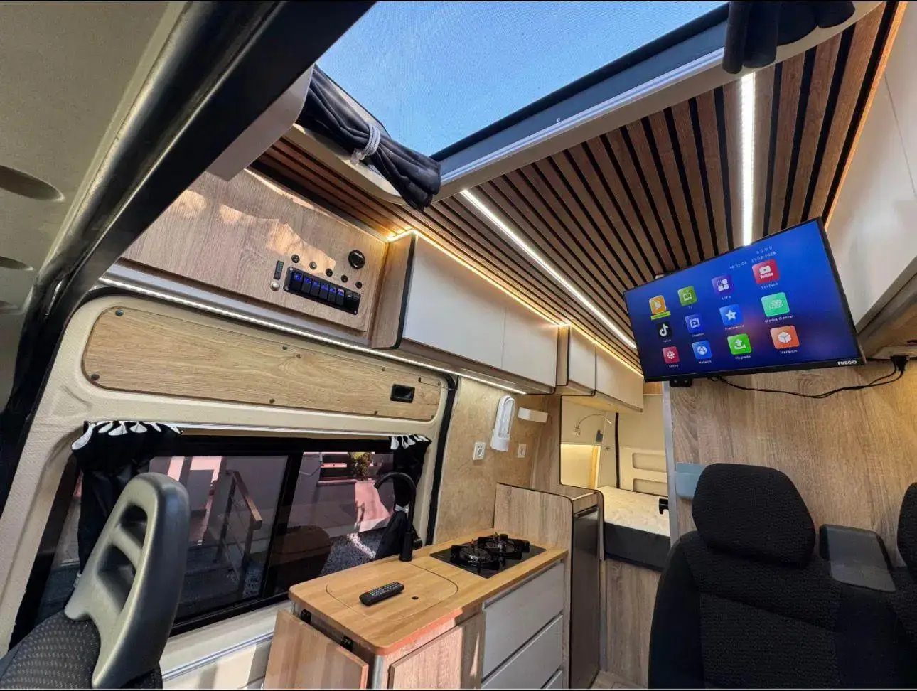 Peugeot Boxer campervan interior with the skylight above the kitchen and seating