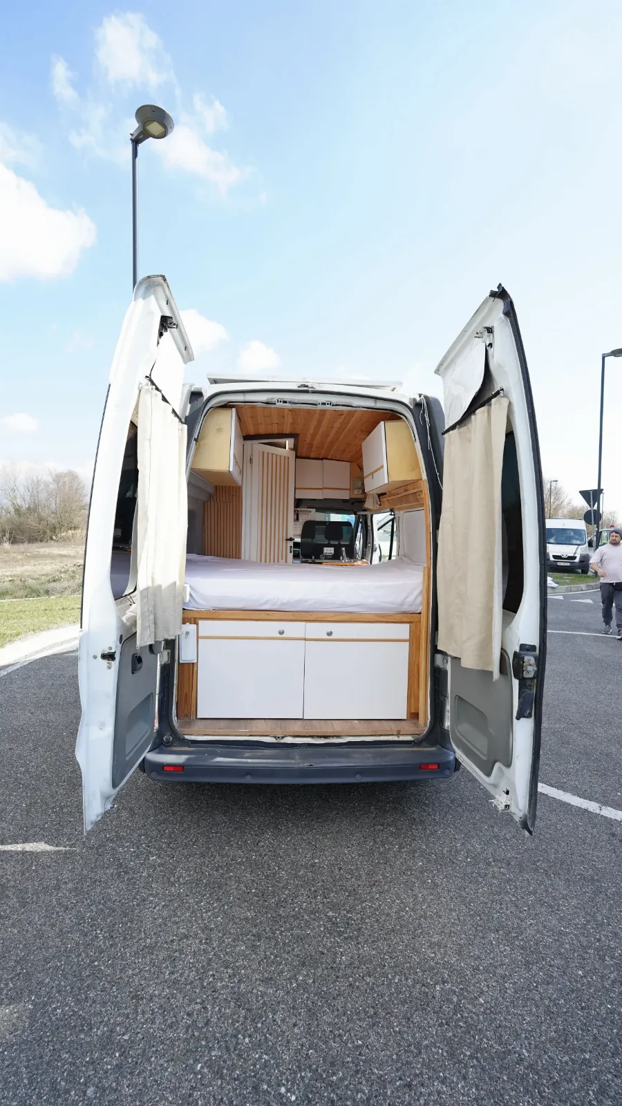 Rear doors open on the Renault Trafic campervan, showing the bed platform