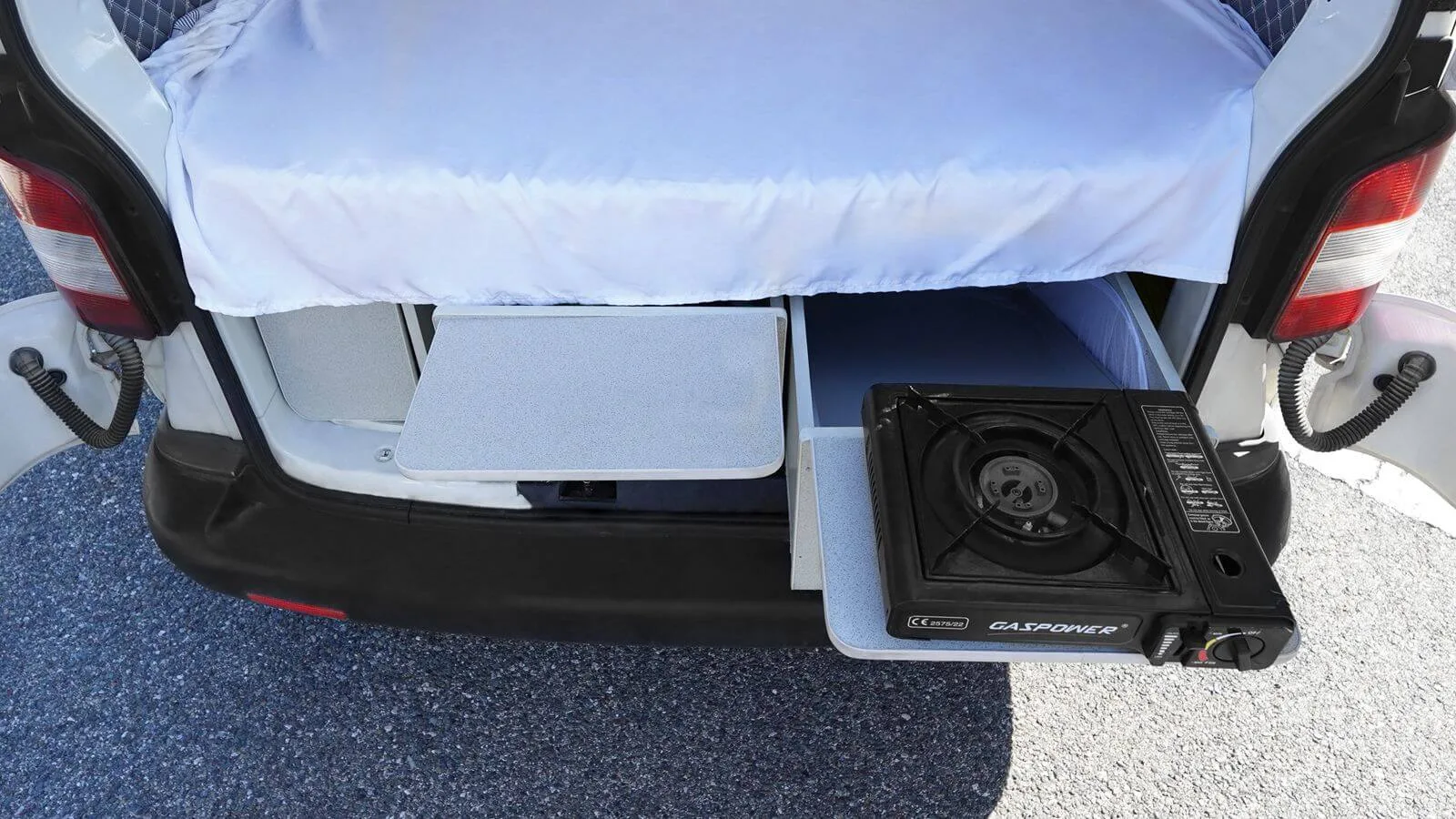 Portable gas stove on a slide-out shelf at the rear of the Volkswagen Transporter T5 campervan