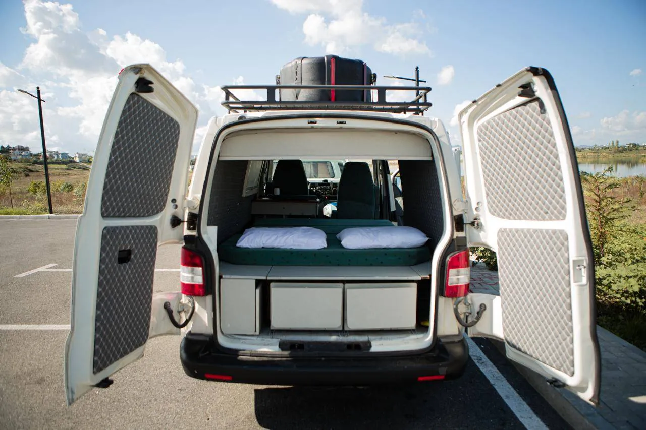 Rear doors open on the Volkswagen Transporter T5 campervan with the roof rack above